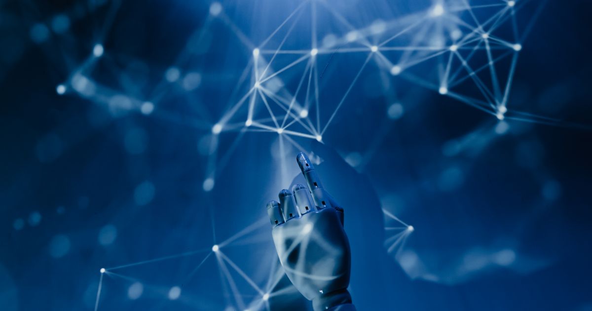 A hand reaching toward a glowing network of connected points